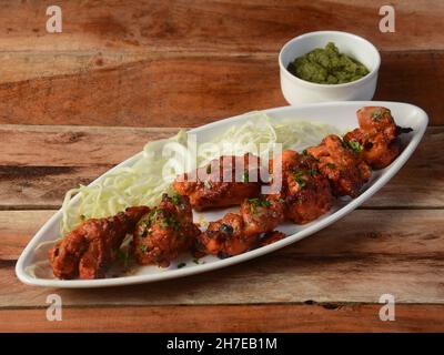 Murgh kebab served on a rustic wooden background. Dishes and appetizers of indian cuisine, selective focus Stock Photo