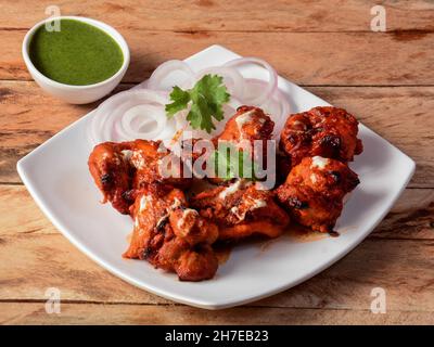 Murgh nizami kebab served on a rustic wooden background. Dishes and appetizers of indian cuisine, selective focus Stock Photo