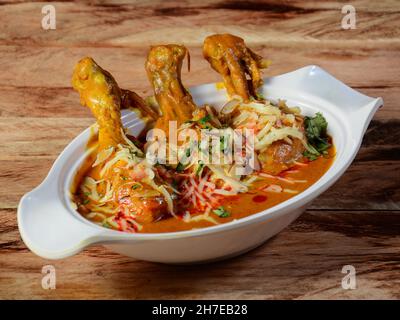Nawabi murgh served on a rustic wooden background. Dishes and appetizers of indian cuisine, selective focus Stock Photo