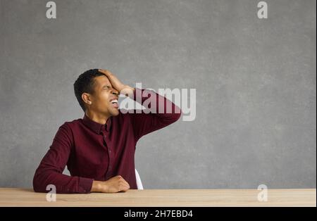 Frustrated African American businessman sits on a chair. Stock Photo