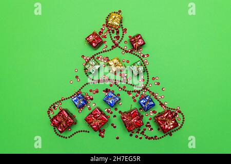 Christmas tree made of Christmas tree decorations and decorations on a green background. Greeting card. Horizontal photo. Stock Photo