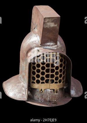 Later murmillo-class gladiator helmet. 3rd Century AD. Isolated over black Stock Photo