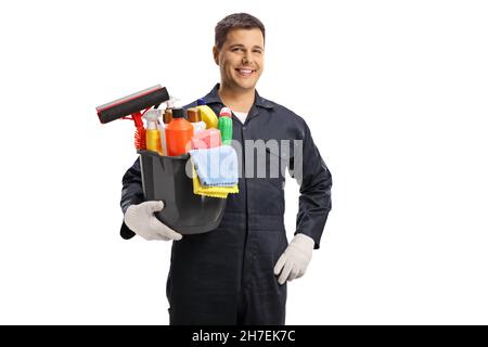 Young male cleaner holding a bucket of cleaning supplies isolated on white background Stock Photo