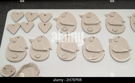 ceramic souvenirs and jewelry in the work process of handmade production. Hand painted and applique Stock Photo