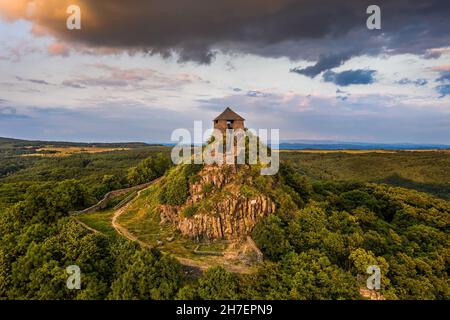 Salgotarjan, Hungary - Aerial view of the ruins of Salgo Castle (Salgo vara) in Nograd county with dark storm clouds above at sunset on a sunny summer Stock Photo
