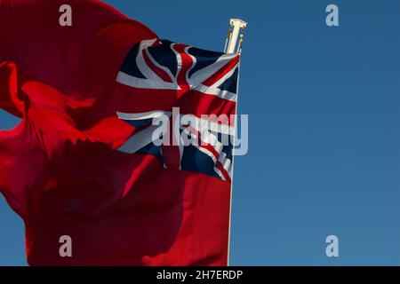 Red Ensign flag also known as the Red Duster.  Flown by British merchantman or civil ships. Stock Photo