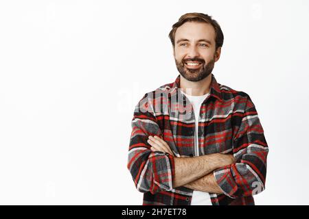 Man with bristle on smiling face in sporty wear, urban background