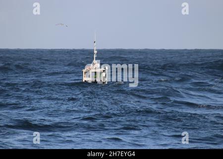 Pilot boat lost in big waves Stock Photo