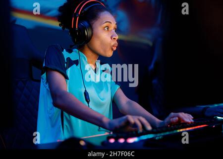 Cute African woman gaming with her friends in cyber club Stock Photo