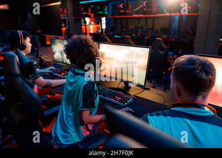 Esports team playing online game on computers in gaming club Stock Photo