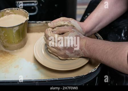Clay modeling training on a potters wheel, clay master class. Art, creativity. Modeling clay, cultural traditions, hobby Stock Photo