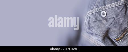 A denim gray jean closeup, banner with space for text. View of old jeans details. Denim background, texture Stock Photo