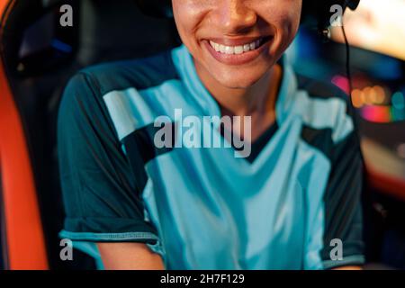 Woman gamer in good mood after tournament in gaming club Stock Photo