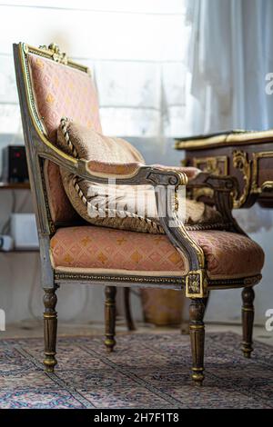 Old vintage wooden armchair on the carpet Stock Photo