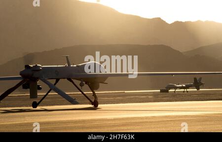 Indian Springs, United States of America. 13 June, 2014. A U.S. Air Force MQ-1 Predator drone, left, and the newer MQ-9 Reaper unmanned aerial vehicle taxi to the runway in preparation for take-off at Creech Air Force Base, June 13, 2014 near Las Vegas, Nevada.  Credit: A1C Christian Clausen/US Air Force Photo/Alamy Live News Stock Photo