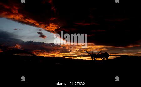 Indian Springs, United States of America. 19 November, 2019. A U.S. Air Force MQ-9 Reaper unmanned aerial vehicle is silhouetted by the setting sun on the ground at Creech Air Force Base, July 19, 2019 near Las Vegas, Nevada.  Credit: A1C William Rio Rosado/US Air Force Photo/Alamy Live News Stock Photo