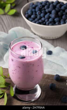 Homemade blueberry yogurt smoothie. Protein shake with berries. Vertical image. Stock Photo