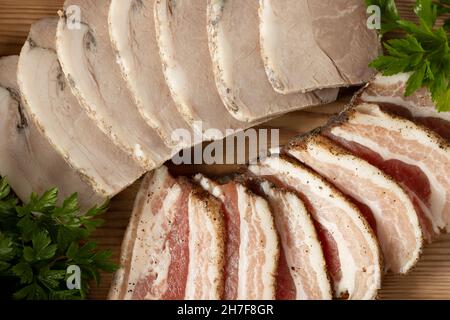 Sliced pork deli meats on wooden platter Stock Photo