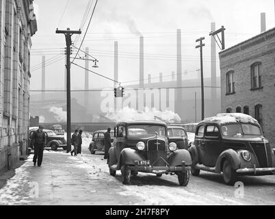 1940's USA Steel Industry Pennsylvania America Cars and steelworkers  leaving the mill in Midland, Pennsylvania Jack Delano, photographer,  working as an employee of the . government 1940 Jan. United  States--Pennsylvania--Beaver County--Midland .