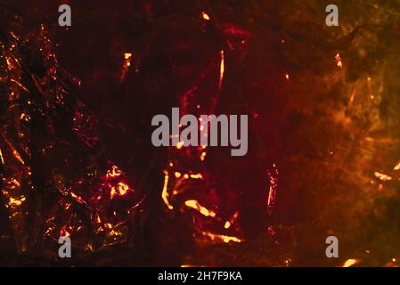 Abstract red background shiny crumpled hologram with sparkles. Trendy neon glowing textured background. Template for creative holiday design Stock Photo