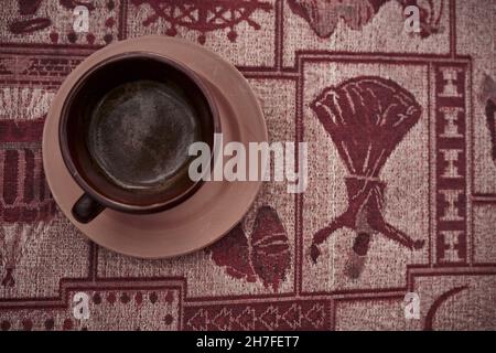 Traditional Turkish coffee inside the traditional and hand made glass made of mud, clay and ceramic Stock Photo