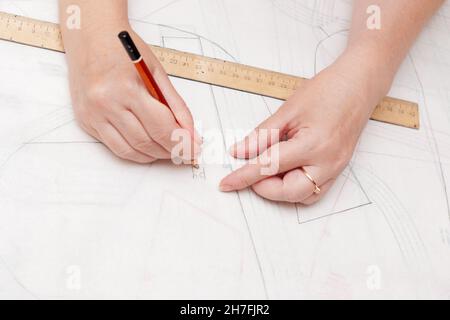 Female designer near big paper sheet with project plan in office Stock  Photo - Alamy