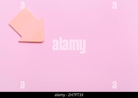 Sticky note papers in shape of arrow on pink background Stock Photo