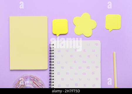 Set of stationery with sticky note papers on lilac background Stock Photo