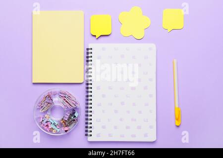 Set of stationery with sticky note papers on lilac background Stock Photo