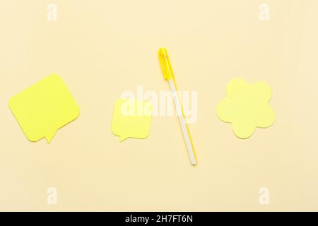 Ball-point pen and sticky notes on color background Stock Photo