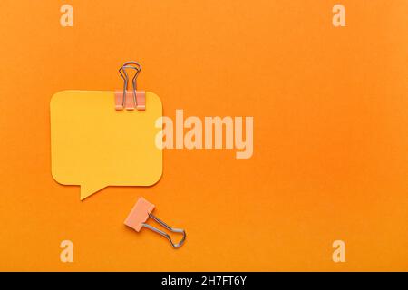 Sticky notes and binder clips on color background Stock Photo
