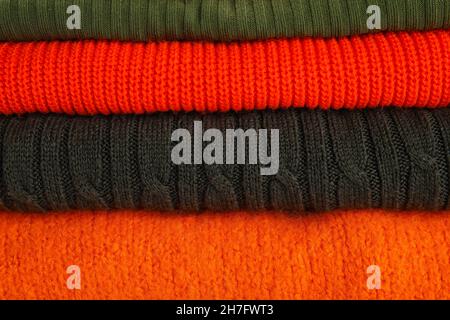 Stack of different stylish sweaters as background Stock Photo