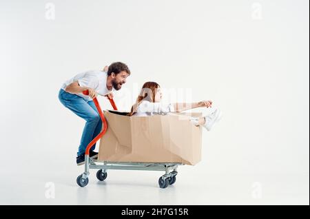 a young couple ride a cart entertainment isolated background Stock Photo