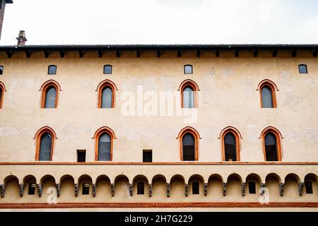 Arched windows and molding on the Castello Sforzesco wall. Milan, Italy Stock Photo