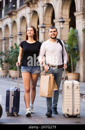 Young smiling couple going the historic city center Stock Photo