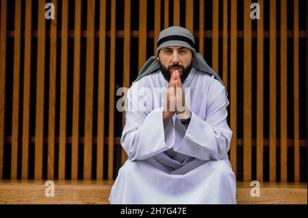 Middle eastern young man in traditional clothing looking thoughtful and concentrated Stock Photo