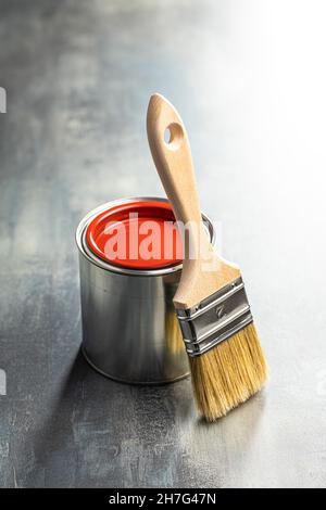 Clean paint brushes and can of color on old table. Stock Photo