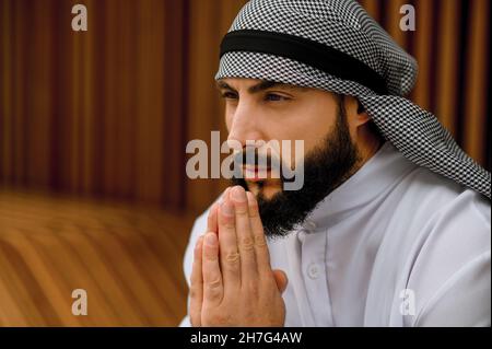 Middle eastern young man in traditional clothing looking thoughtful and concentrated Stock Photo