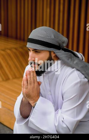 Middle eastern young man in traditional clothing looking thoughtful and concentrated Stock Photo