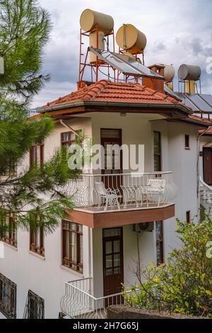 Barrels of water heated by solar batteries installed on roof of house ...