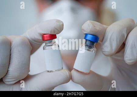 Blank label for your text and design on the bottle with the liquid. Scientific development of vaccines in the laboratory. Testing of vaccines. The con Stock Photo