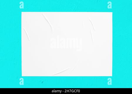 mint green urban wall with wrinkled glued poster template Stock Photo