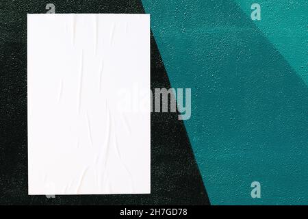 close up of colorful urban wall texture with wrinkled glued poster template Stock Photo