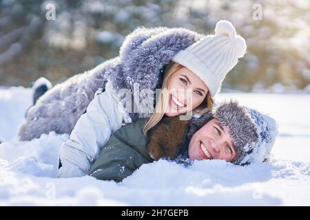 Couple having fun in winter scenery and snow Stock Photo