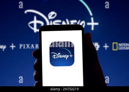 The Disney streaming app Disney+ logo is seen on the screen of a mobile phone and the display of a laptop in Barcelona, Spain on November 16, 2021 Stock Photo