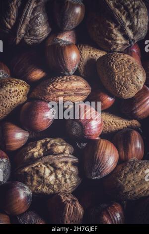 A full frame food background of a variety of mixed nuts including Walnuts, Almonds, Hazelnuts and Brazil nuts with copy space Stock Photo