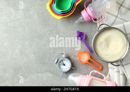 Concept of baby food with рowdered milk on gray textured background Stock Photo