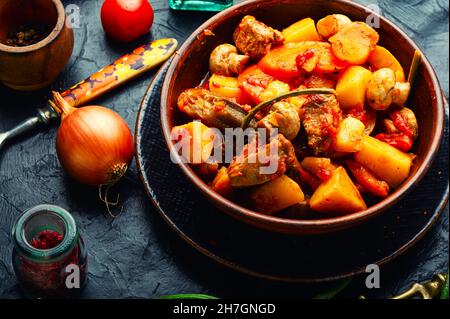 Meat ragout with mushrooms, zucchini, tomato and potatoes. Roast meat Stock Photo