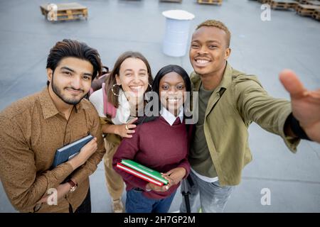 Students looking at camera at university campus Stock Photo