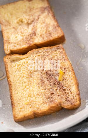 Frying french toast in a nonstick frying pan. Stock Photo